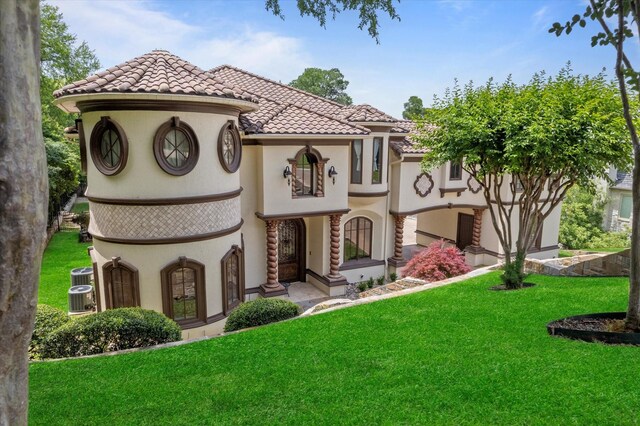1608 Rivercrest Ct, Fort Worth, TX 76107 - mediterranean / spanish-style home featuring a front lawn, a tile roof, stucco siding, and cooling unit