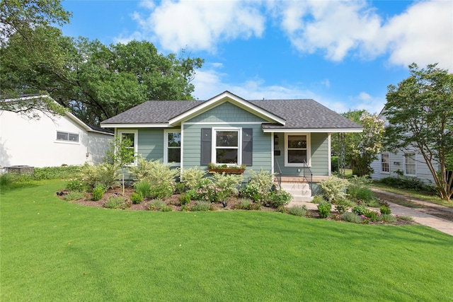 3819 Hubby Ave, Waco, TX 76710 - view of front of home with a front lawn, a shingled roof, and a porch