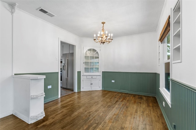 3819 Hubby Ave, Waco, TX 76710 - spare room with wainscoting, a chandelier, hardwood / wood-style floors, and ornamental molding