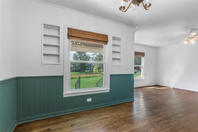 3819 Hubby Ave, Waco, TX 76710 - unfurnished room with a chandelier, wainscoting, built in features, wood finished floors, and crown molding