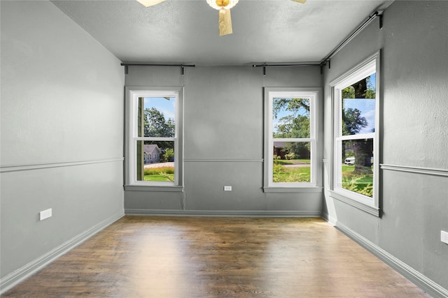 3819 Hubby Ave, Waco, TX 76710 - spare room featuring wood finished floors, a textured ceiling, ceiling fan, and healthy amount of natural light