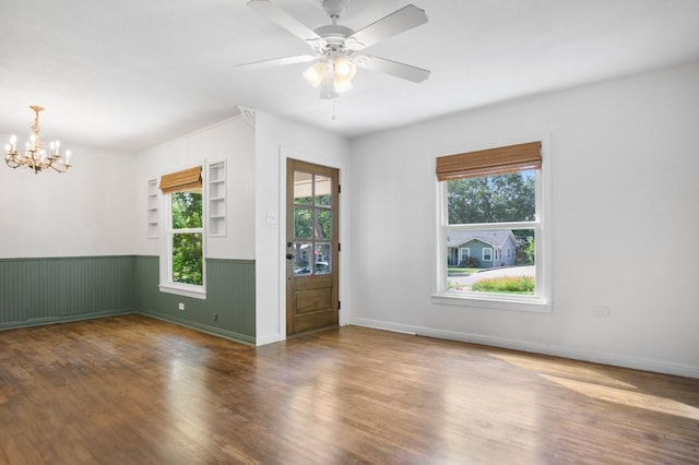 3819 Hubby Ave, Waco, TX 76710 - unfurnished room with a chandelier, wood finished floors, a wainscoted wall, and ceiling fan