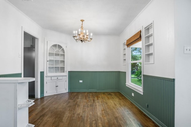 3819 Hubby Ave, Waco, TX 76710 - unfurnished dining area featuring wainscoting, ornamental molding, a chandelier, dark wood finished floors, and built in features