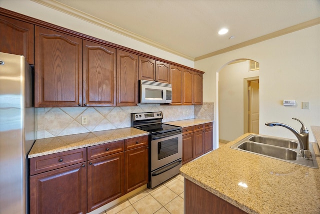 1891 Signal Ridge Pl, Rockwall, TX 75032 - kitchen with appliances with stainless steel finishes, a sink, arched walkways, decorative backsplash, and crown molding