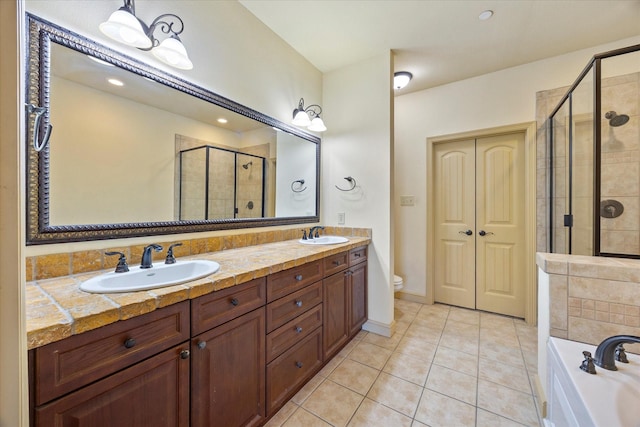 1891 Signal Ridge Pl, Rockwall, TX 75032 - full bath featuring a stall shower, double vanity, a garden tub, tile patterned flooring, and toilet