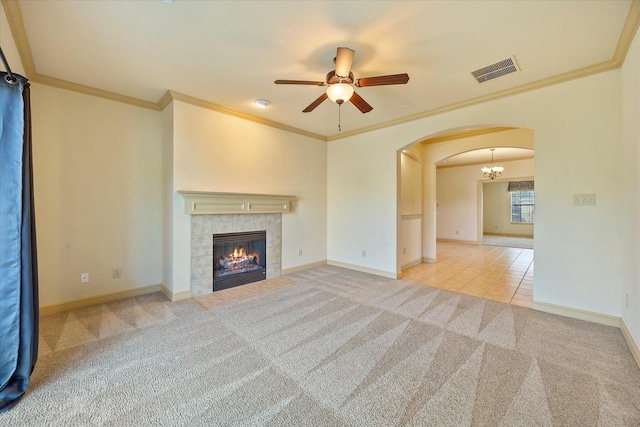 1891 Signal Ridge Pl, Rockwall, TX 75032 - unfurnished living room with arched walkways, carpet floors, a ceiling fan, ornamental molding, and a tiled fireplace