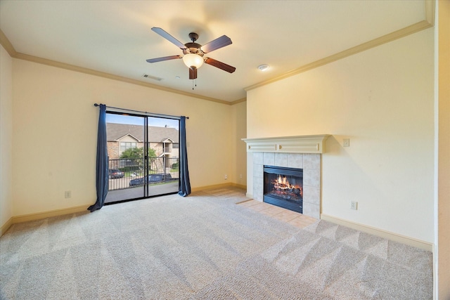 1891 Signal Ridge Pl, Rockwall, TX 75032 - unfurnished living room featuring crown molding, carpet floors, baseboards, a ceiling fan, and a tiled fireplace
