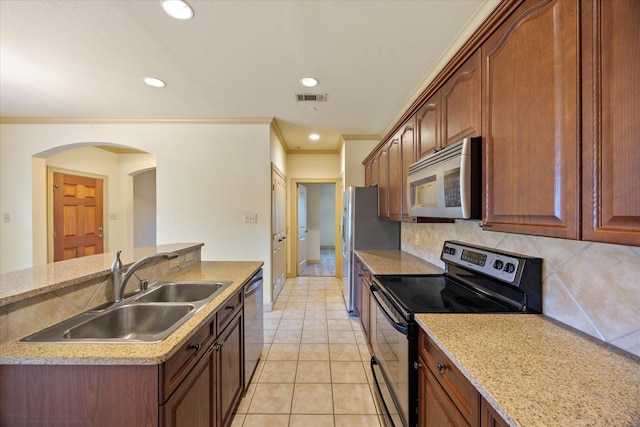 1891 Signal Ridge Pl, Rockwall, TX 75032 - kitchen with appliances with stainless steel finishes, a sink, arched walkways, decorative backsplash, and recessed lighting