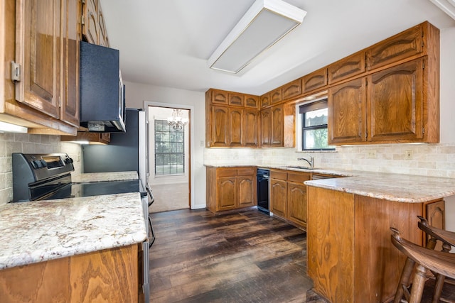 2126 Los Robles St, Grapevine, TX 76051 - kitchen with brown cabinetry, a sink, dark wood-style floors, electric range, and tasteful backsplash