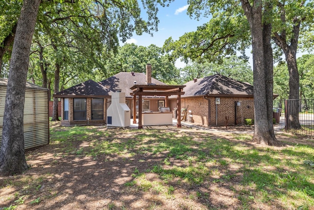 2126 Los Robles St, Grapevine, TX 76051 - back of house with brick siding, a chimney, a pergola, and an outbuilding