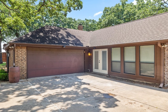 2126 Los Robles St, Grapevine, TX 76051 - view of front of property featuring roof with shingles, driveway, an attached garage, brick siding, and a chimney