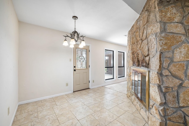 2126 Los Robles St, Grapevine, TX 76051 - entrance foyer with a chandelier, a stone fireplace, and baseboards