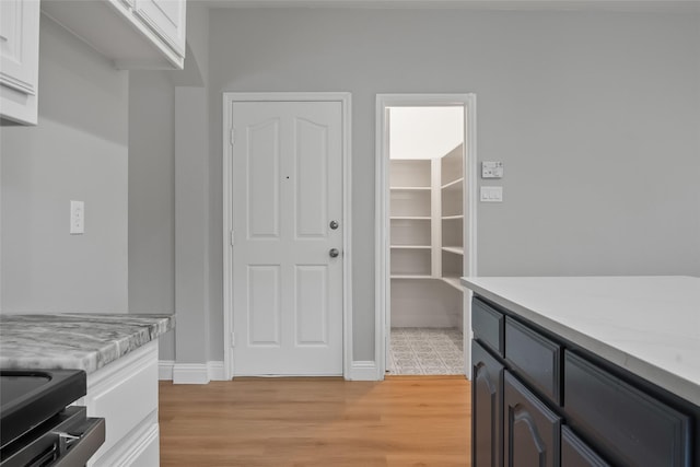 10833 Hawks Landing Rd, Fort Worth, TX 76052 - interior space featuring light countertops, white cabinetry, light wood-type flooring, and baseboards