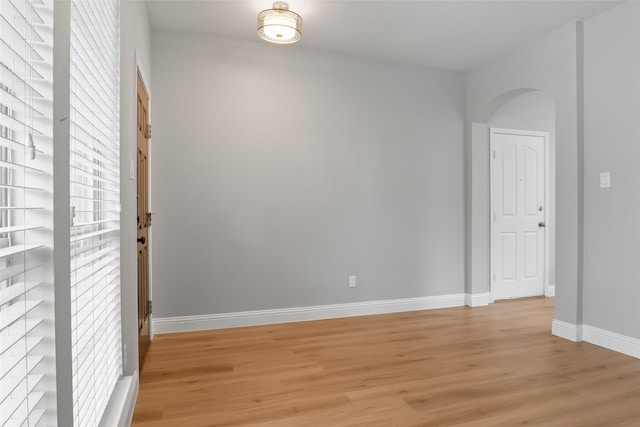 10833 Hawks Landing Rd, Fort Worth, TX 76052 - empty room with light wood-type flooring, baseboards, and arched walkways