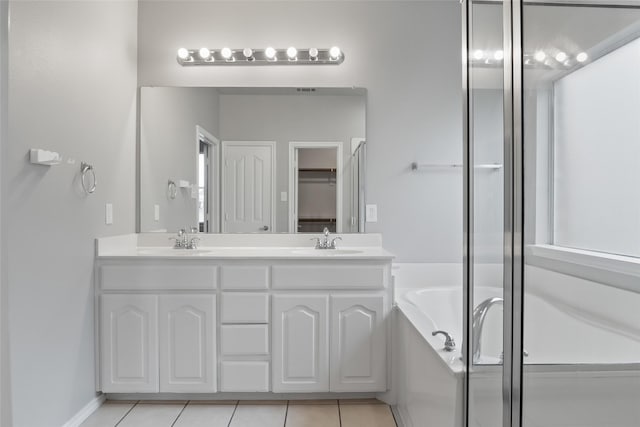 10833 Hawks Landing Rd, Fort Worth, TX 76052 - bathroom featuring double vanity, a garden tub, tile patterned floors, and a closet