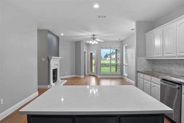 10833 Hawks Landing Rd, Fort Worth, TX 76052 - kitchen featuring stainless steel dishwasher, a center island, white cabinets, ceiling fan, and recessed lighting