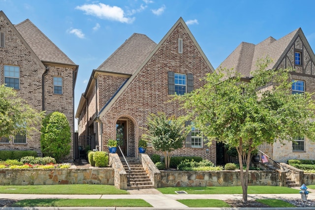 232 Skystone Dr, Irving, TX 75038 - tudor-style house featuring brick siding and roof with shingles
