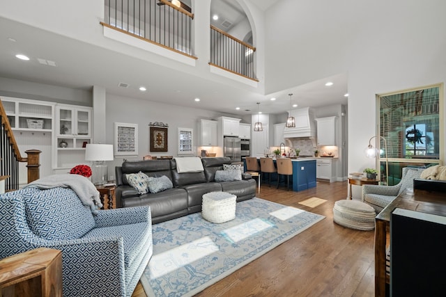 232 Skystone Dr, Irving, TX 75038 - living area with a high ceiling, light wood-style floors, stairway, and recessed lighting