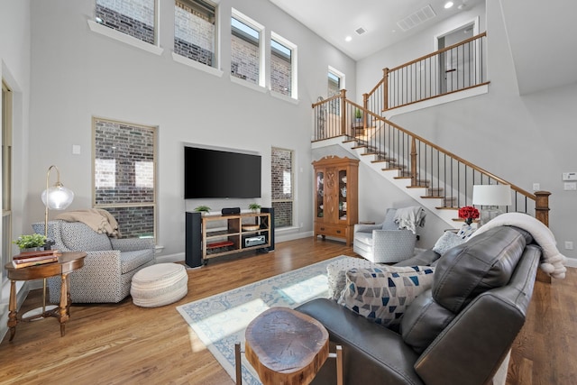 232 Skystone Dr, Irving, TX 75038 - living area with a towering ceiling, stairs, wood finished floors, baseboards, and recessed lighting