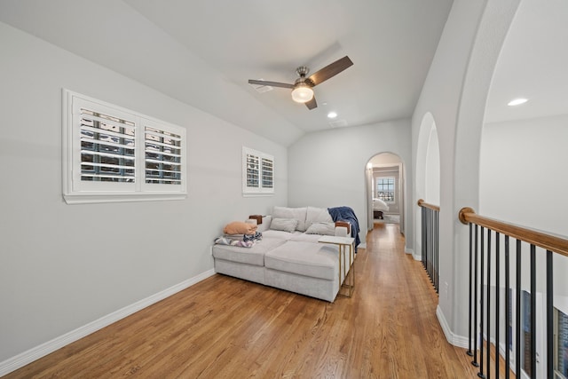 232 Skystone Dr, Irving, TX 75038 - bedroom with arched walkways, light wood-style flooring, baseboards, vaulted ceiling, and recessed lighting