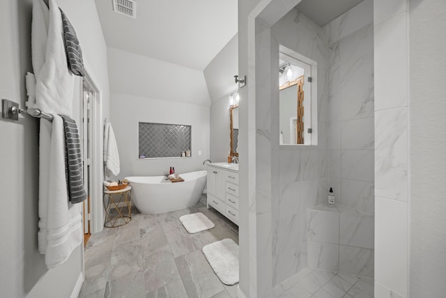 232 Skystone Dr, Irving, TX 75038 - bathroom with vanity, marble look tiles, a freestanding bath, and tiled shower