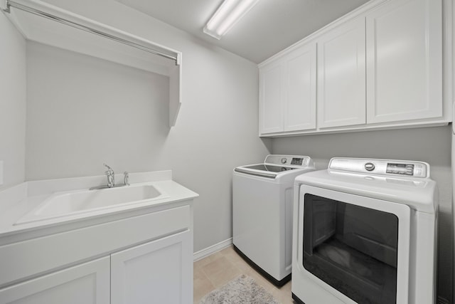 232 Skystone Dr, Irving, TX 75038 - laundry room featuring independent washer and dryer, cabinet space, and baseboards