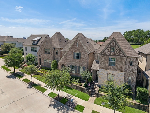 232 Skystone Dr, Irving, TX 75038 - tudor-style house featuring brick siding, stone siding, and a shingled roof
