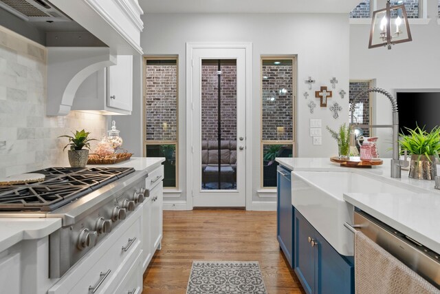232 Skystone Dr, Irving, TX 75038 - kitchen with blue cabinets, stainless steel appliances, light countertops, and tasteful backsplash