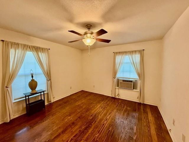 511 W Bonham Ave, Cooper, TX 75432 - empty room with wood finished floors, ceiling fan, cooling unit, and baseboards