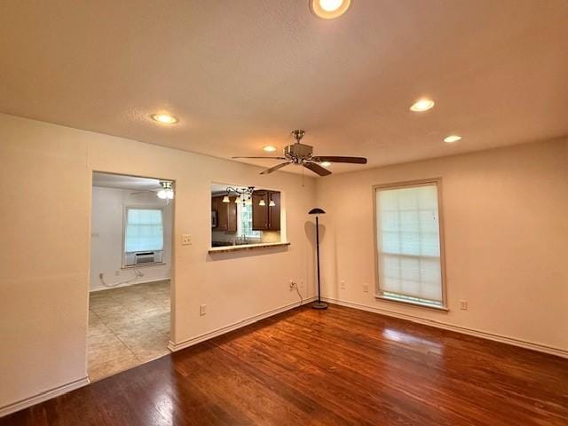 511 W Bonham Ave, Cooper, TX 75432 - unfurnished room with a ceiling fan, wood finished floors, recessed lighting, cooling unit, and baseboards