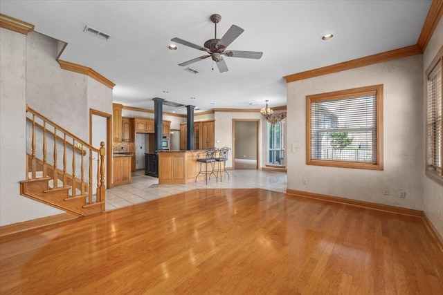 3633 Cliff View Loop, Weatherford, TX 76087 - unfurnished living room featuring ornamental molding, decorative columns, light wood-style flooring, ceiling fan, and baseboards