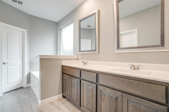 817 Nicole Way, Fort Worth, TX 76028 - full bath featuring double vanity, a bath, wood finished floors, and baseboards
