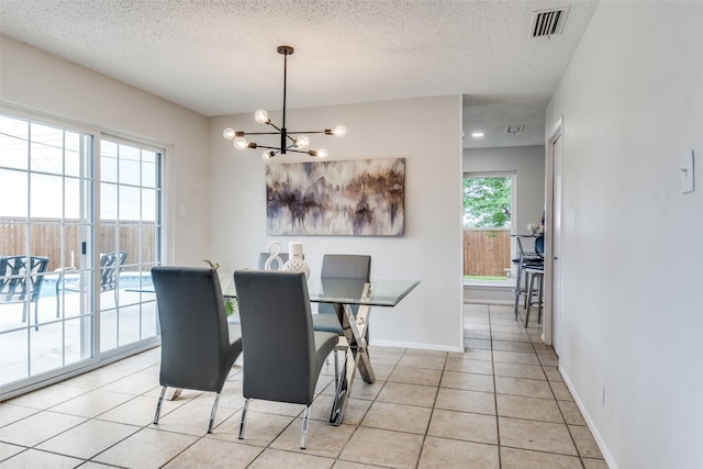 4000 Via Plata, Mesquite, TX 75150 - dining space with a chandelier, a textured ceiling, light tile patterned floors, and baseboards