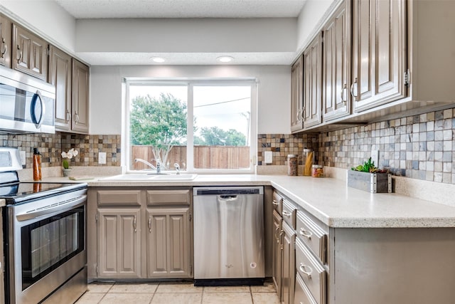 4000 Via Plata, Mesquite, TX 75150 - kitchen with appliances with stainless steel finishes, a sink, light countertops, and tasteful backsplash