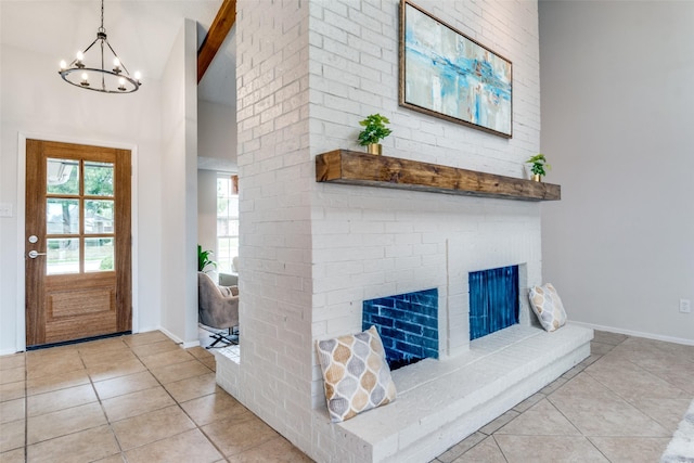 4000 Via Plata, Mesquite, TX 75150 - tiled entrance foyer with high vaulted ceiling, a chandelier, baseboards, and a brick fireplace