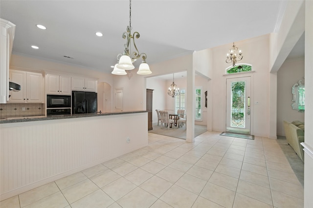 2004 Kodiak Ct, Arlington, TX 76013 - kitchen with black appliances, a chandelier, tasteful backsplash, ornamental molding, and ventilation hood
