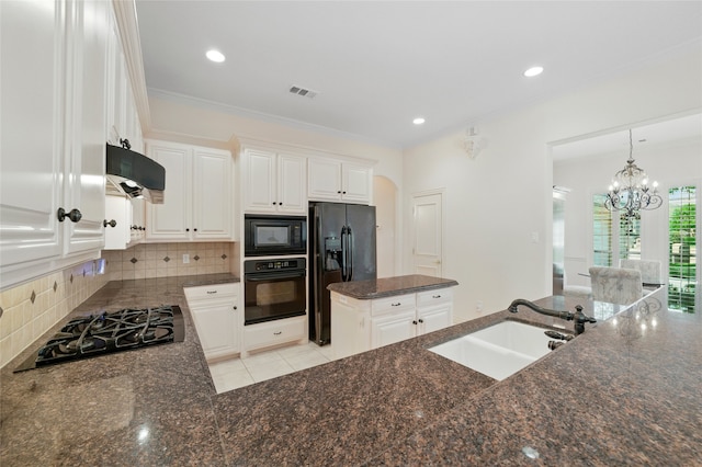 2004 Kodiak Ct, Arlington, TX 76013 - kitchen with black appliances, tasteful backsplash, dark stone countertops, crown molding, and exhaust hood