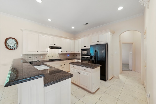 2004 Kodiak Ct, Arlington, TX 76013 - kitchen featuring black appliances, arched walkways, a peninsula, under cabinet range hood, and decorative backsplash