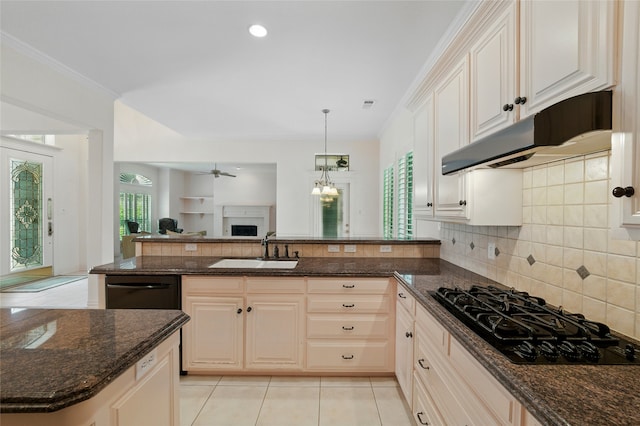 2004 Kodiak Ct, Arlington, TX 76013 - kitchen featuring black gas cooktop, open floor plan, decorative backsplash, dark stone counters, and recessed lighting