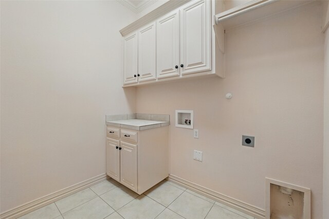 2004 Kodiak Ct, Arlington, TX 76013 - laundry area with electric dryer hookup, cabinet space, hookup for a washing machine, light tile patterned floors, and crown molding