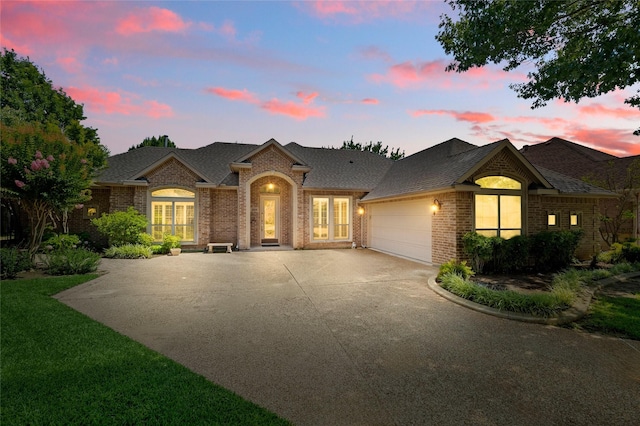 2004 Kodiak Ct, Arlington, TX 76013 - view of front of property with brick siding, concrete driveway, an attached garage, and roof with shingles