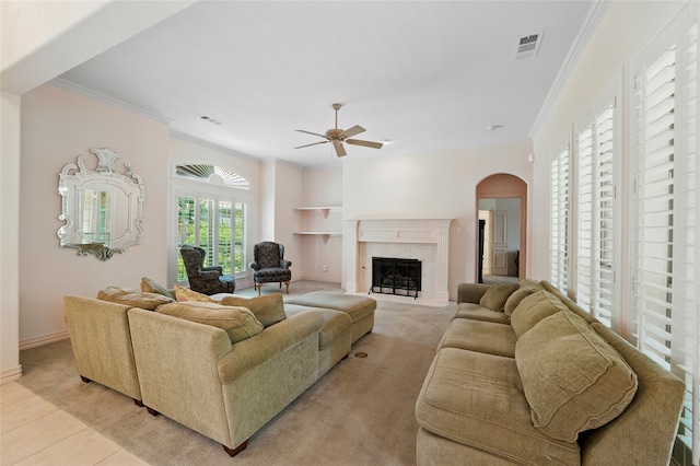 2004 Kodiak Ct, Arlington, TX 76013 - living room featuring ceiling fan, light colored carpet, built in shelves, arched walkways, and ornamental molding