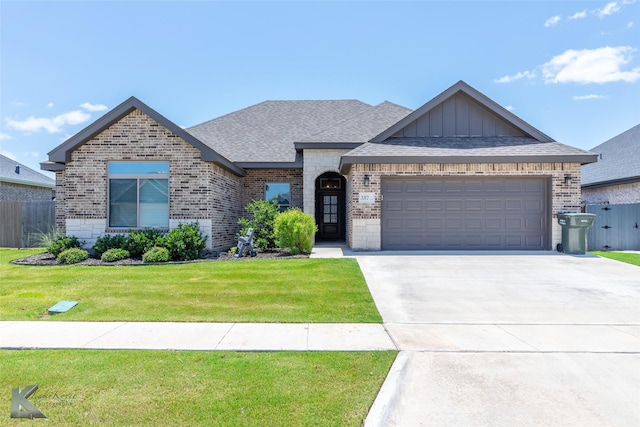 357 Blue Lake Dr, Abilene, TX 79602 - french country inspired facade with brick siding, board and batten siding, a garage, and driveway
