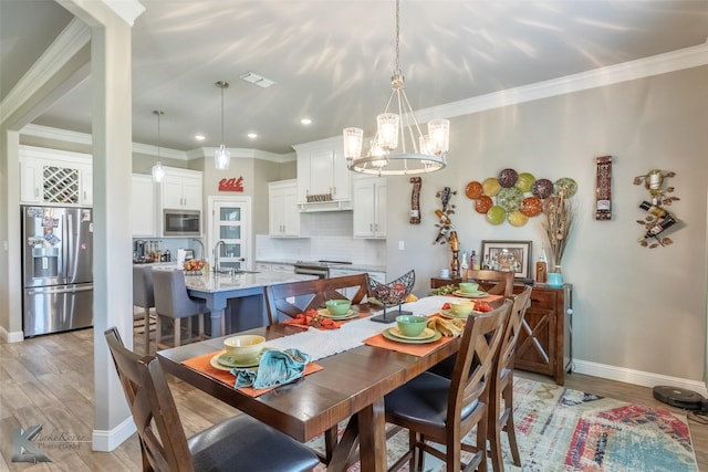 357 Blue Lake Dr, Abilene, TX 79602 - dining area with a chandelier, baseboards, ornamental molding, light wood finished floors, and recessed lighting