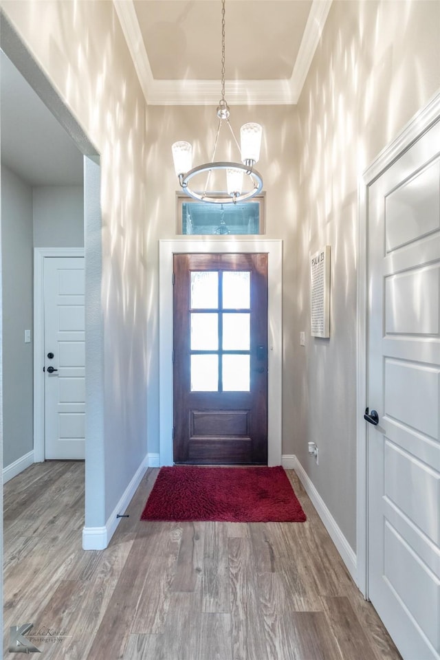 357 Blue Lake Dr, Abilene, TX 79602 - entryway with baseboards, wood finished floors, ornamental molding, and a chandelier