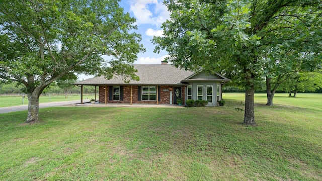 5691 Priscilla Ln, Kaufman, TX 75142 - view of front of home featuring a front lawn, brick siding, a chimney, driveway, and a shingled roof