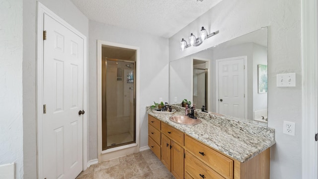 5691 Priscilla Ln, Kaufman, TX 75142 - bathroom featuring vanity, a shower stall, a textured ceiling, and baseboards