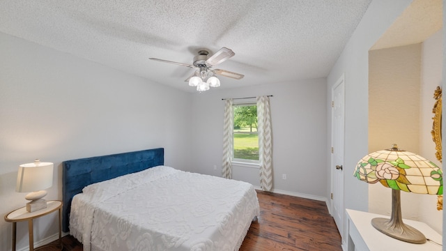 5691 Priscilla Ln, Kaufman, TX 75142 - bedroom with dark wood-style flooring, a textured ceiling, baseboards, and ceiling fan