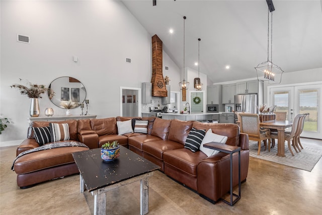 243 Fm 203, Walnut Springs, TX 76690 - living room featuring high vaulted ceiling, concrete floors, and french doors