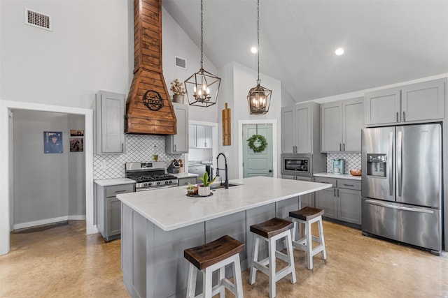 243 Fm 203, Walnut Springs, TX 76690 - kitchen featuring appliances with stainless steel finishes, gray cabinets, decorative backsplash, a chandelier, and high vaulted ceiling